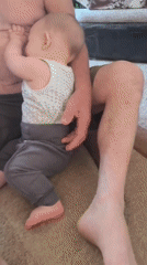 Father and baby captured in intimate floor moment