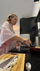 Woman cooking in kitchen observed in Vozdovac, Serbia