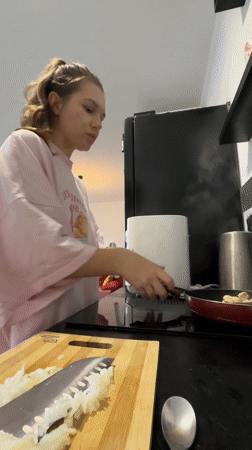 Woman cooking in kitchen observed in Vozdovac, Serbia