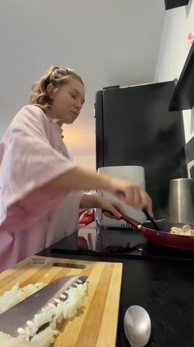 Woman cooking in kitchen observed in Vozdovac, Serbia