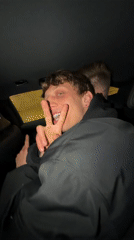 Young man makes hand gestures in car in Moscow