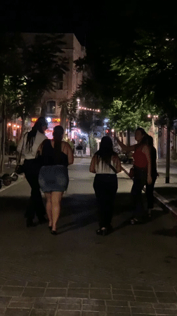 Tel Aviv street nightlife, bars full, chairs being cleared