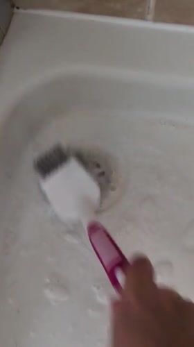 Scrubbing down a bathtub in Telford