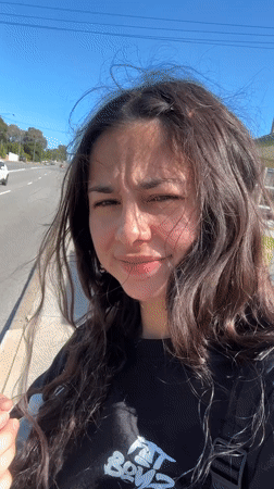 Woman filmed walking, speaking to camera on Bicton sidewalk
