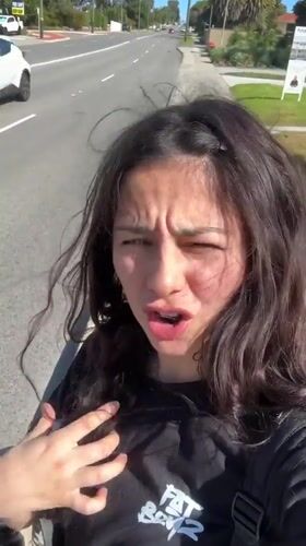 Woman filmed walking, speaking to camera on Bicton sidewalk