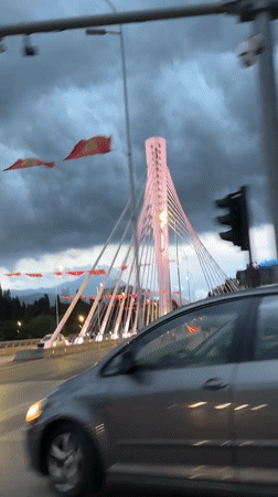 Rainy evening drive past Millennium Bridge in Podgorica captured