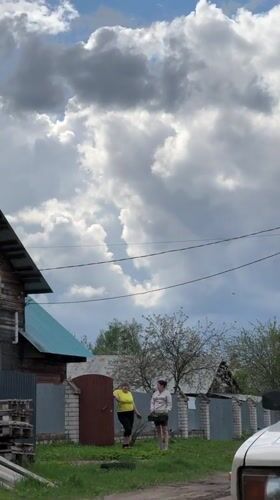 Two women filmed near fence in rural Chuprino, Russia