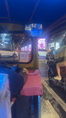 Rainy night tuk-tuk ride through Bangkok streets