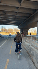 Woman cycles under Montreal overpass on Sunday evening