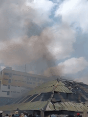 Fire burns through Nairobi settlement, leaving debris and crowds