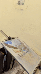 Artist paints watercolors on cobblestone street in Cuzco