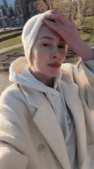 Woman photographs sunny spring day in Yekaterinburg street scene