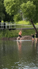 Young people rope swing at pond in Satino-Russkoe Russia
