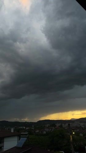 Dramatic storm clouds meet golden sunset over Kardzhali, Bulgaria