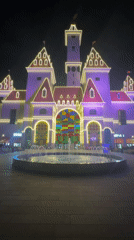 Moscow's illuminated nightscape: lit buildings, colored fountains, red sports cars