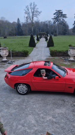 Young driver in red Porsche spotted on gravel road