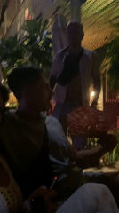 Nighttime social gathering captured at outdoor venue in Mũi Né