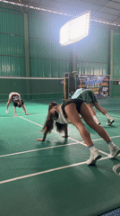 Group exercises and plays badminton at Thai indoor court