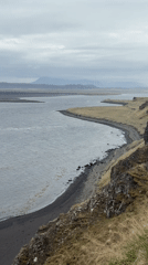 Tourist documents Hvítserkur sea stack during Iceland coastal visit