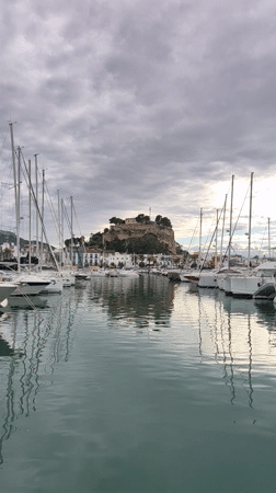 Tourist explores Dénia's marina, restaurants, and historic sites