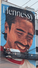 Mural in progress on a Brooklyn building facade