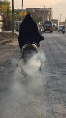 Scooter produces heavy white smoke on Indonesian road