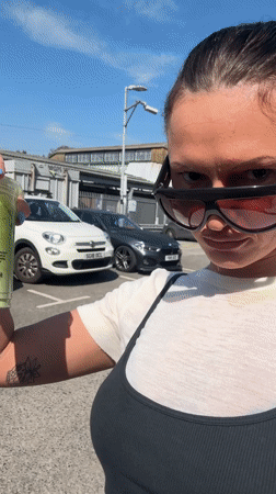 Woman documents sunny afternoon outing with green drink in Waverley