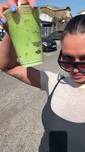Woman documents sunny afternoon outing with green drink in Waverley