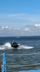 Jet skiing on a calm Belarusian lake under open skies