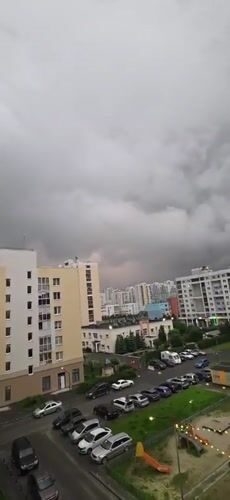 Time-lapse clouds drift over Yekaterinburg apartment skyline