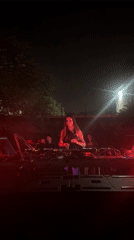 Female DJ performs at smoky outdoor night event in Sofia