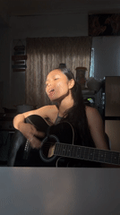 Acoustic guitar session in dramatic side-lit room, Davao City