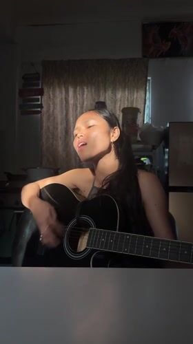 Acoustic guitar session in dramatic side-lit room, Davao City