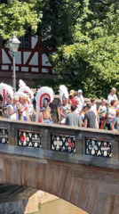 Pride parade rolls across Nuremberg's stone bridge in summer