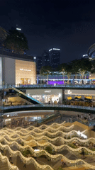 Evening crowds gather at illuminated Tianhe District shopping center