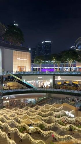 Evening crowds gather at illuminated Tianhe District shopping center