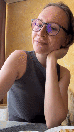 Woman smiles at camera during morning moment in Khimki