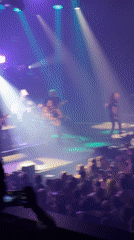 Rock band performs live concert to packed crowd