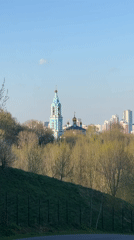 Moscow hillside with blue bell tower building captured