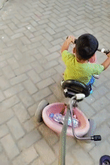 Backyard grilling and kids playing on a dusty Mekarmukti lot