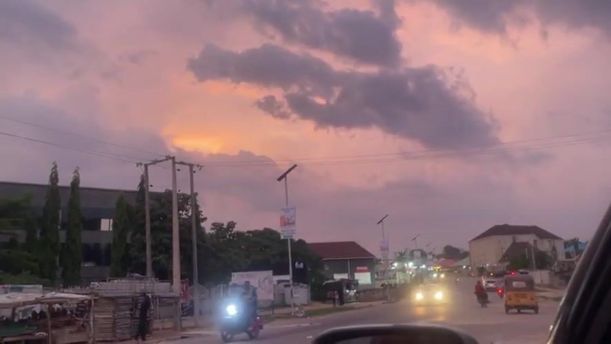 Evening street life documented in Abuja during sunset
