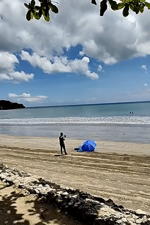 Morning beach walk captured in sunny Kuta Selatan