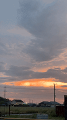 Cloudy sunset breaks orange over Taganrog rooftops