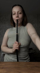 Woman smokes hookah indoors in Reshetnikovo, Russia