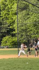 Baseball player practices hitting off tee in New York