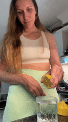 Woman prepares lemon water in Turkish kitchen