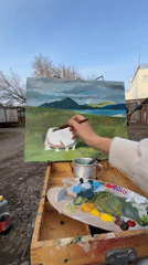Artist paints pastoral landscape with cow outdoors in Krasnoyarsk