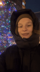 Woman films winter moments near Christmas tree in Kazan