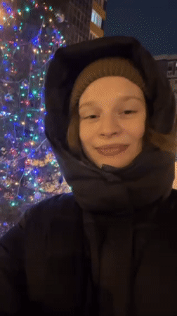 Woman films winter moments near Christmas tree in Kazan