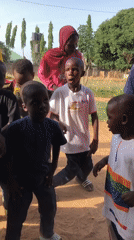 Children celebrate with decorated cake, dancing in Akwanga, Nigeria